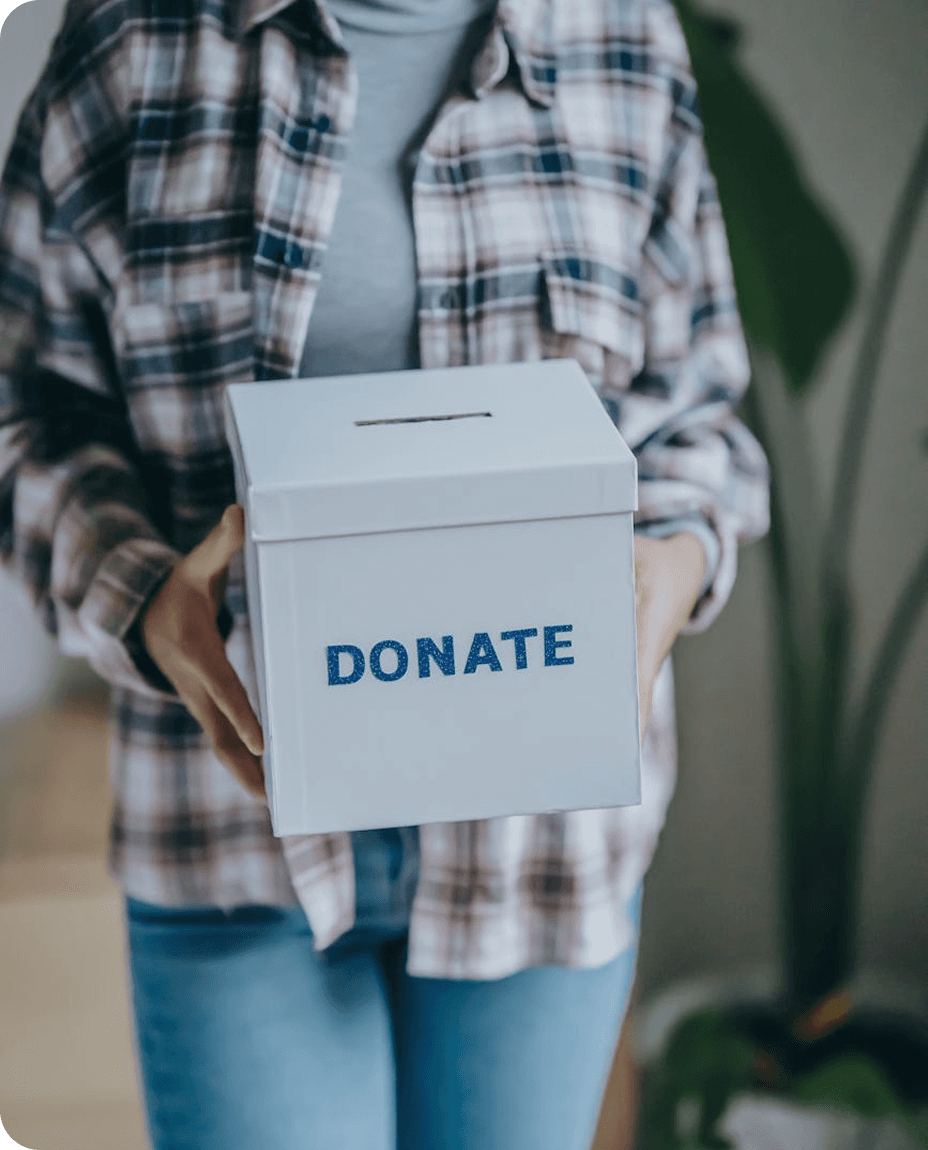 Volunteer holding a donation collection box